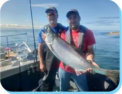 Two men holding a fish on the boat