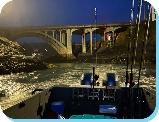 A boat is in the water near a bridge.