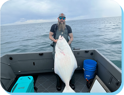 A man holding a large fish on top of a boat.