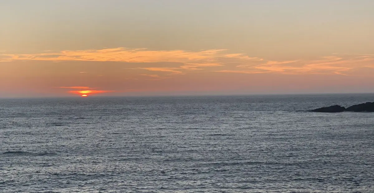 A view of the ocean at sunset from an island.